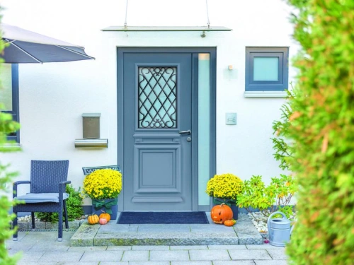 Porte d'entrée alu gris ardoise AFC à grille décorative et vitrage latéral, façade Calvados.