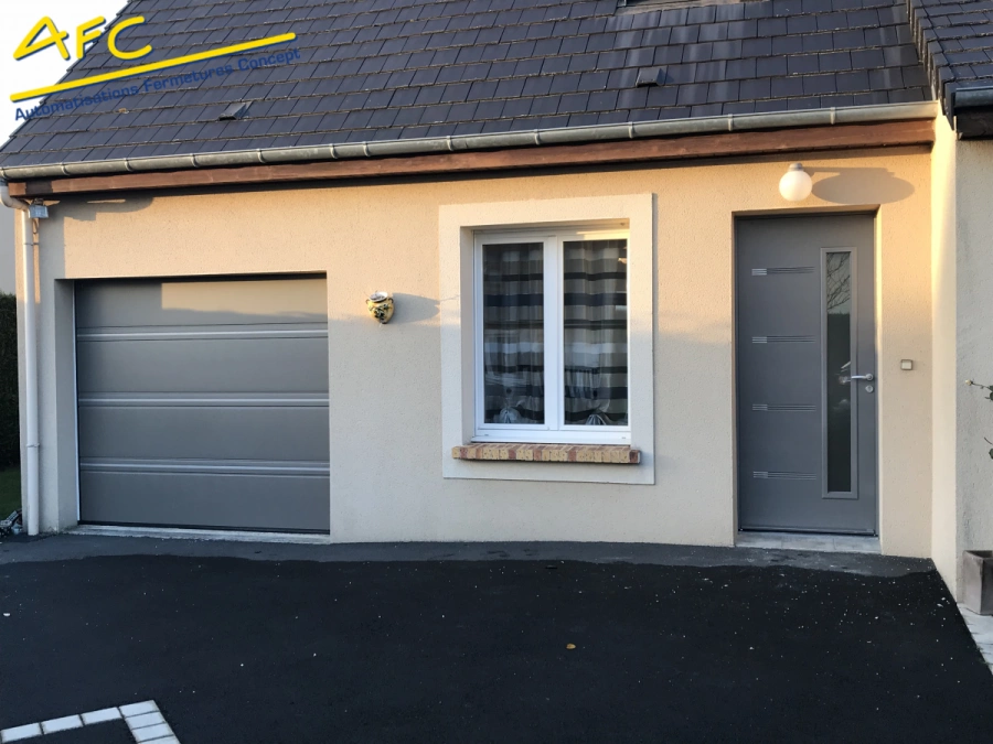 Porte de garage sectionnelle et porte d'entrée anthracite assorties sur maison crépie, AFC Caen