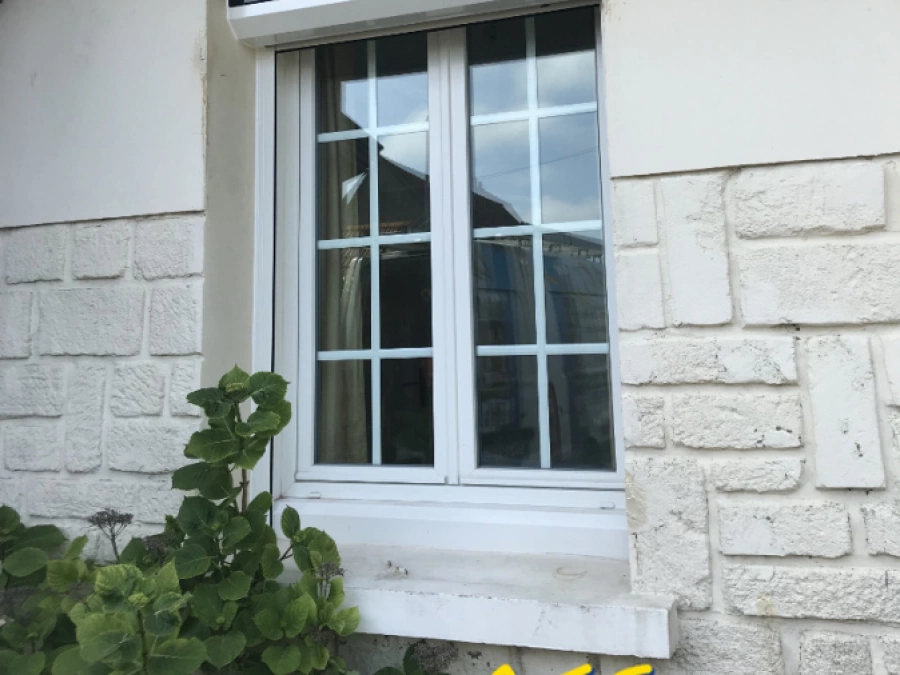 Volet roulant solaire blanc avec panneau photovoltaïque sur caisson, façade maison AFC Normandie